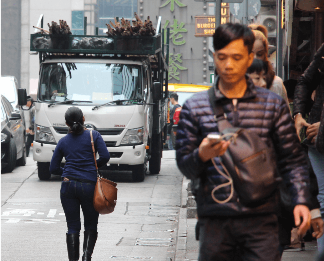 Traffic occupies most of the use of the street. Sidewalks are narrow and some of them cross through the roads.